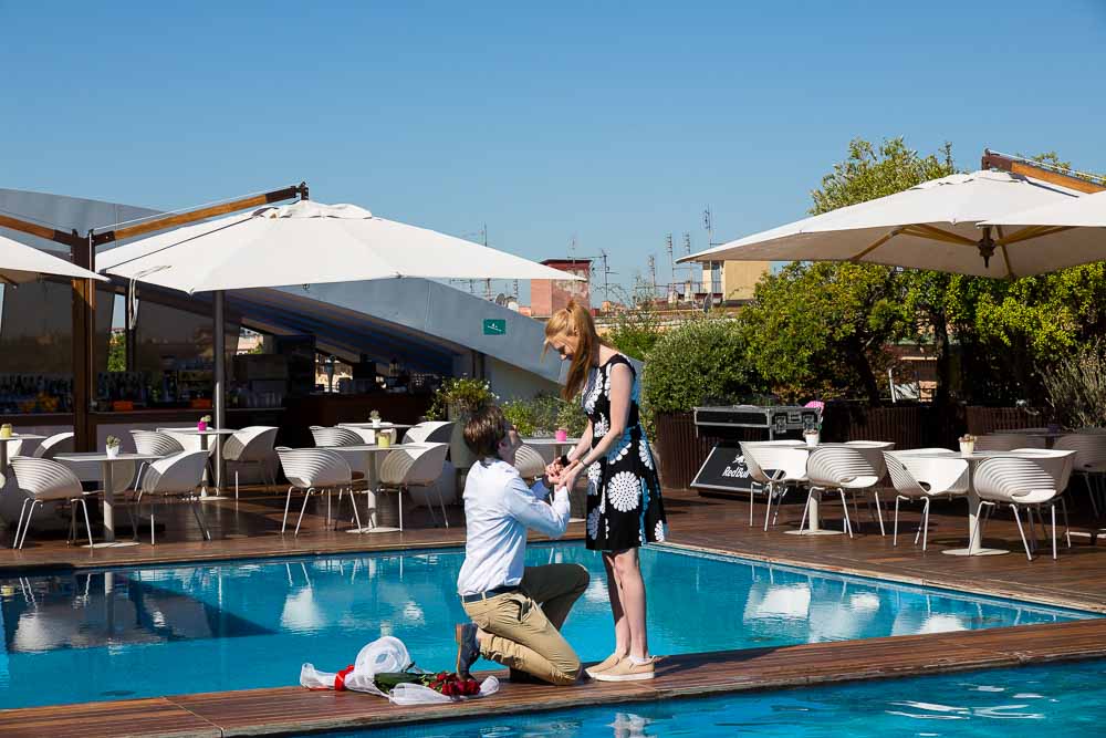 Romantic poolside surprise wedding proposal in a Hotel roof garden