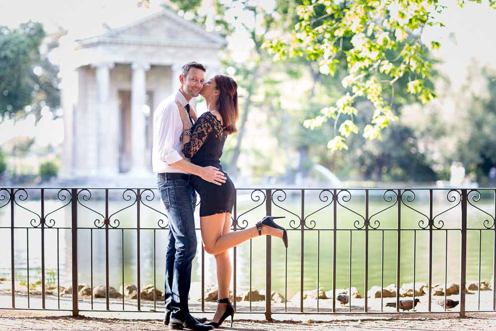 Kissing at water edge during an engagement session