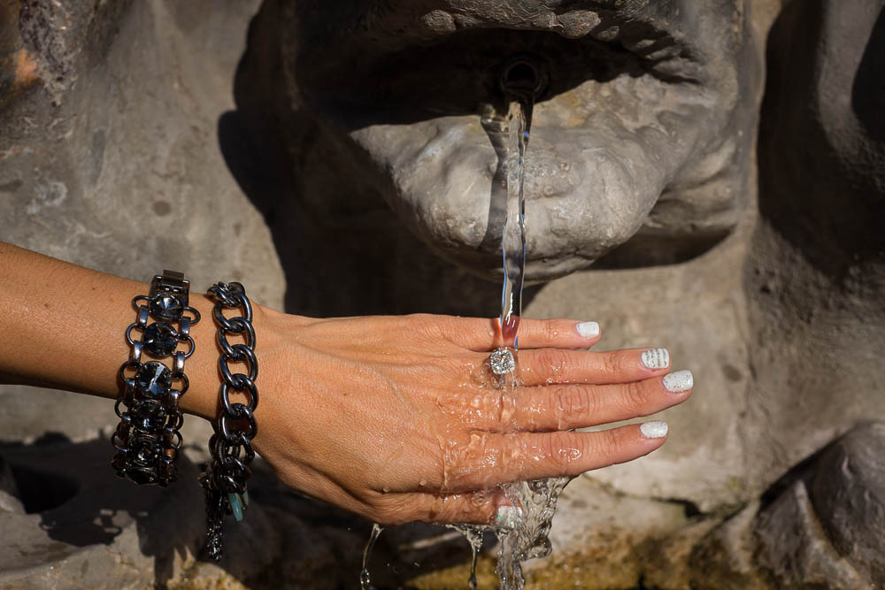 Engagement ring photographed under fountain water