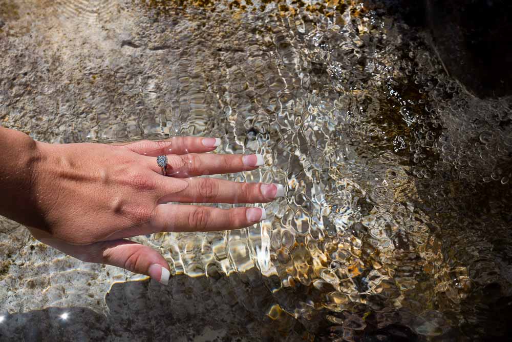 Hand in the water engagement ring photography