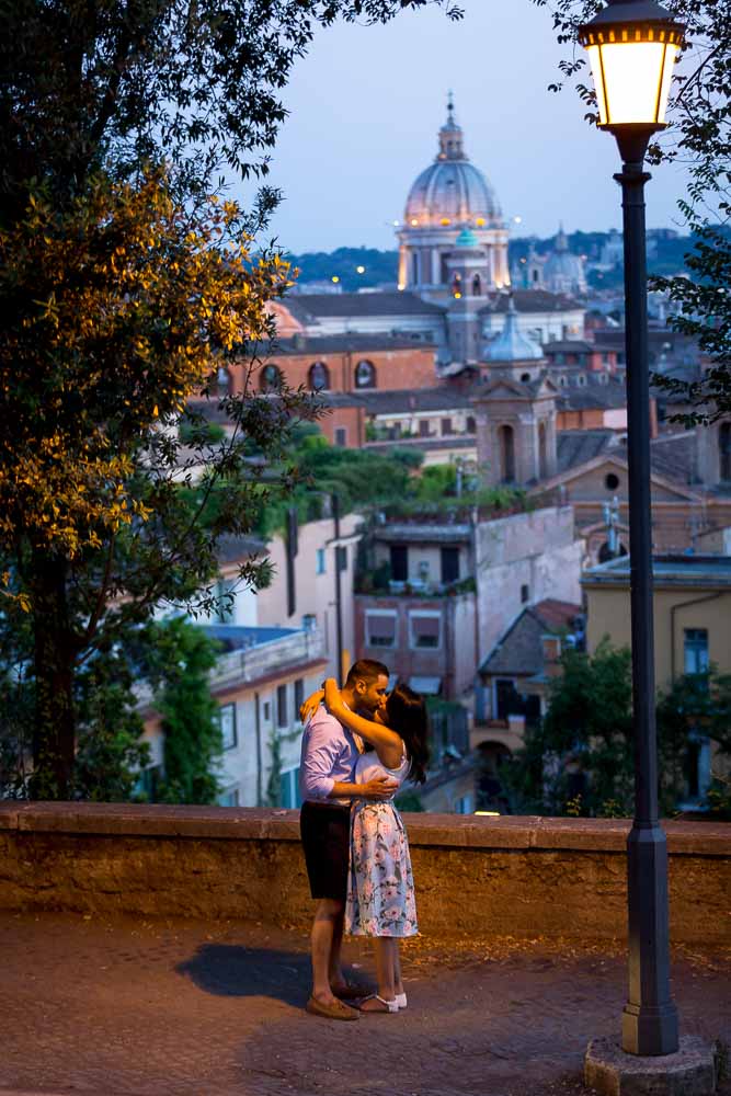 Engagement photo session under street lamp post at dusk in Rome Italy