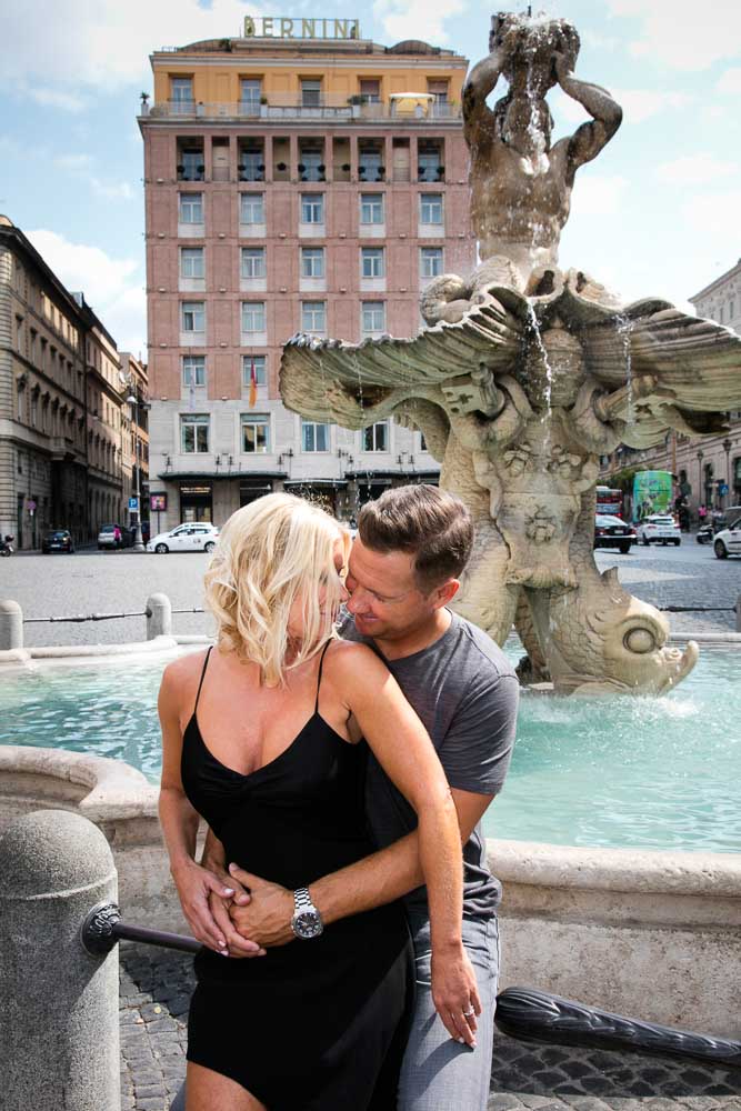 Portrait picture taken before the Baroque water fountain found in Piazza Barberini in Rome