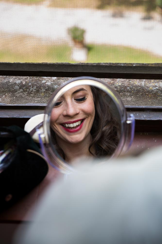 Woman smiling through the mirror reflection