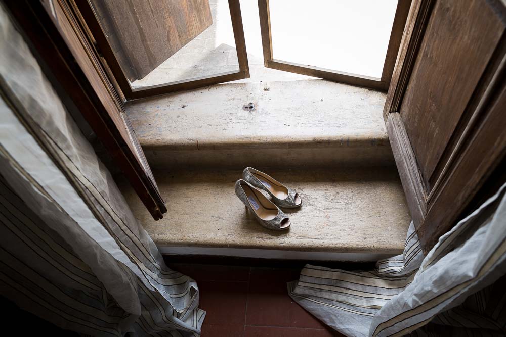 Bridal shoes photographed on the steps by window light