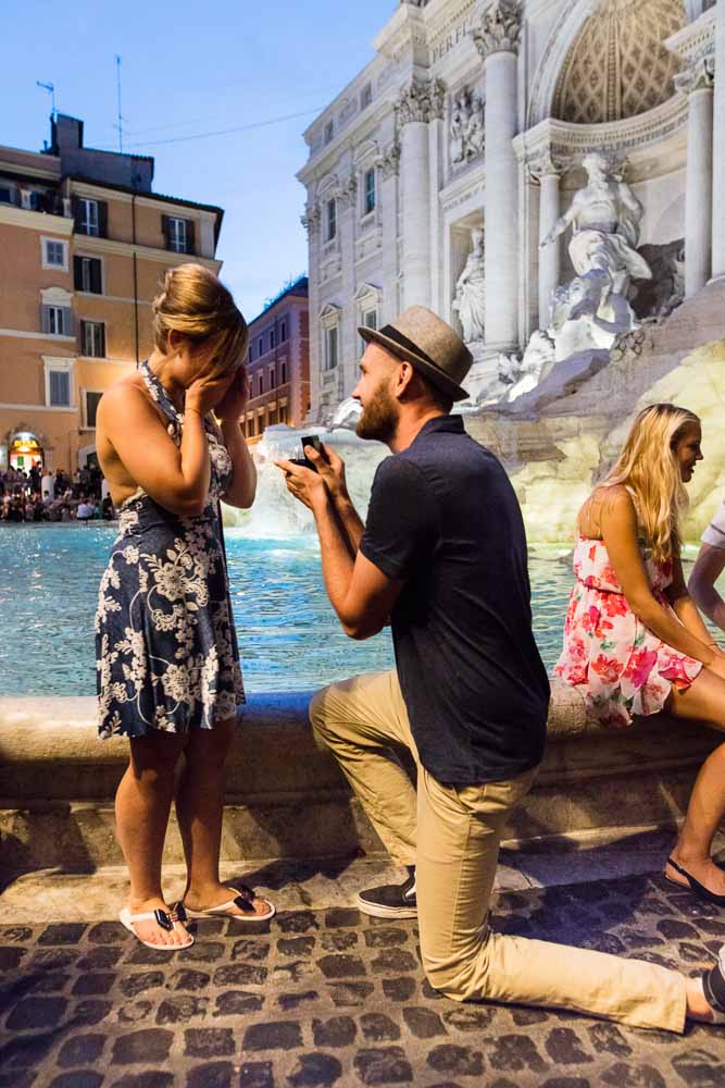 Knee down nighttime wedding proposal in Rome