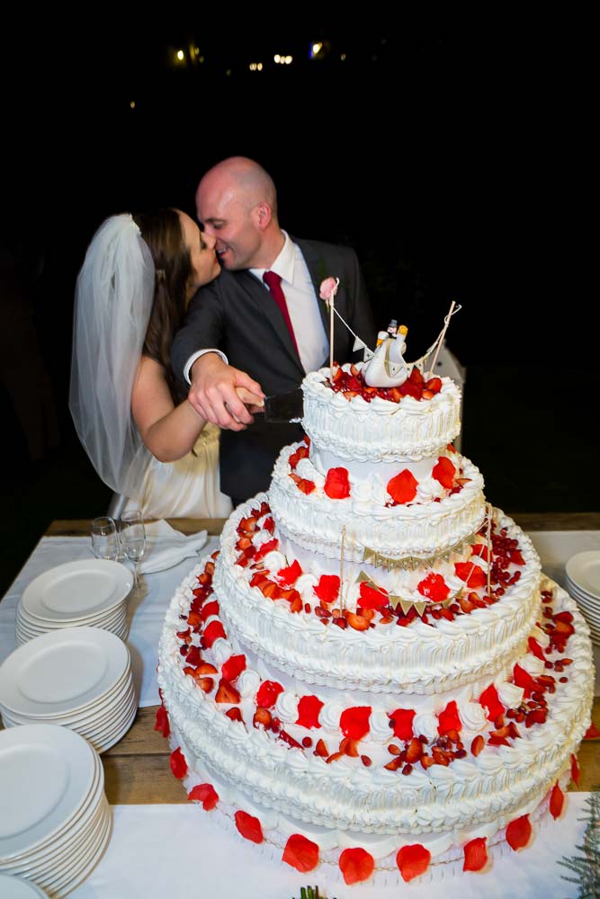 Kissing while cutting the wedding cake