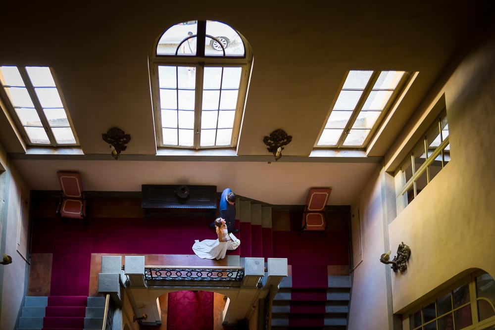 Newlyweds walking together descending stairs photographed from the above terrace