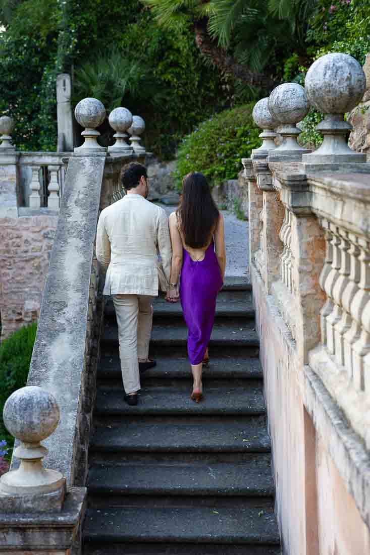 Walking up the staircase of Italian style architecture during a photoshoot to celebrate the engagement 