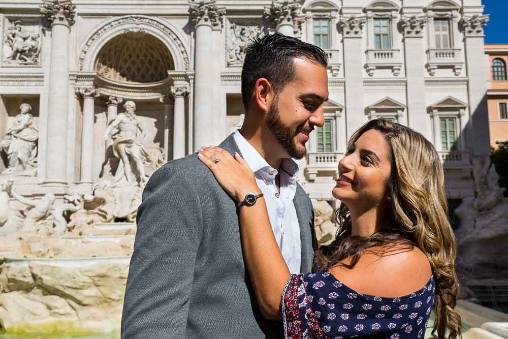 Couple together during a photo shoot in front of the Trevi fountain