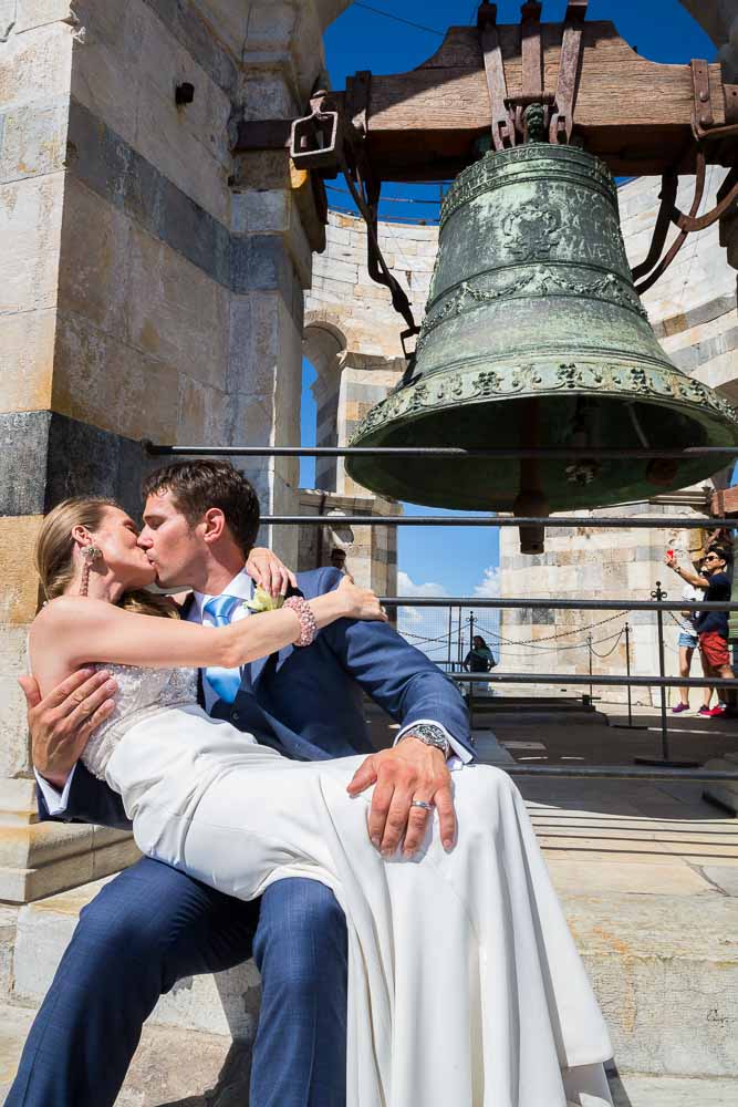 Kissing under the bells. Destination Wedding Photography in Pisa Tuscany 