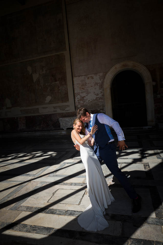 Picture of a just married couple in between light and shadow