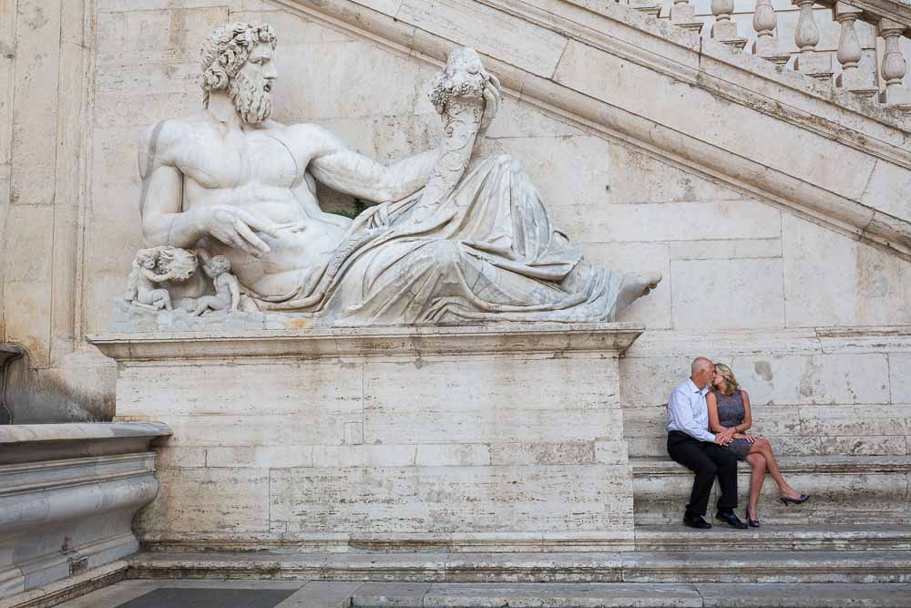 Sitting underneath a large statue