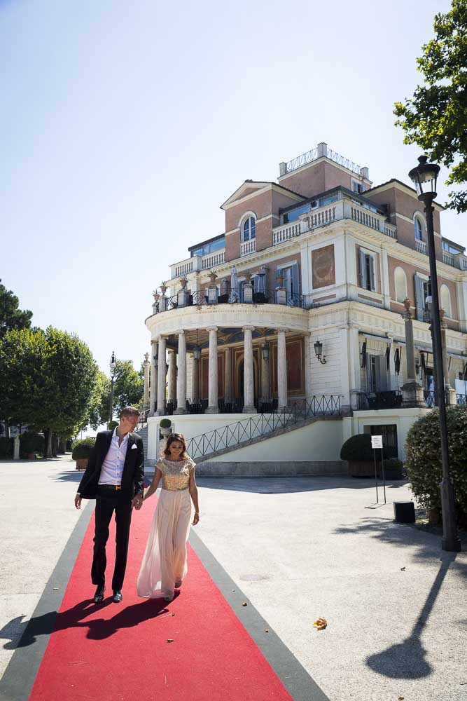 Walking on a red carpet out of a restaurant