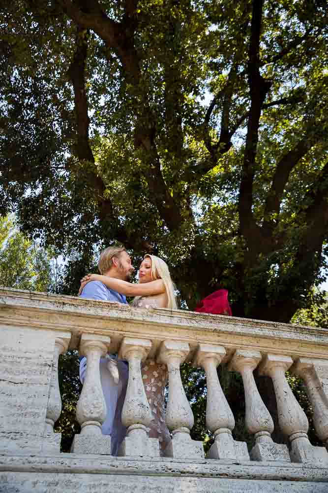 Kissing under illuminated park trees in Rome Italy