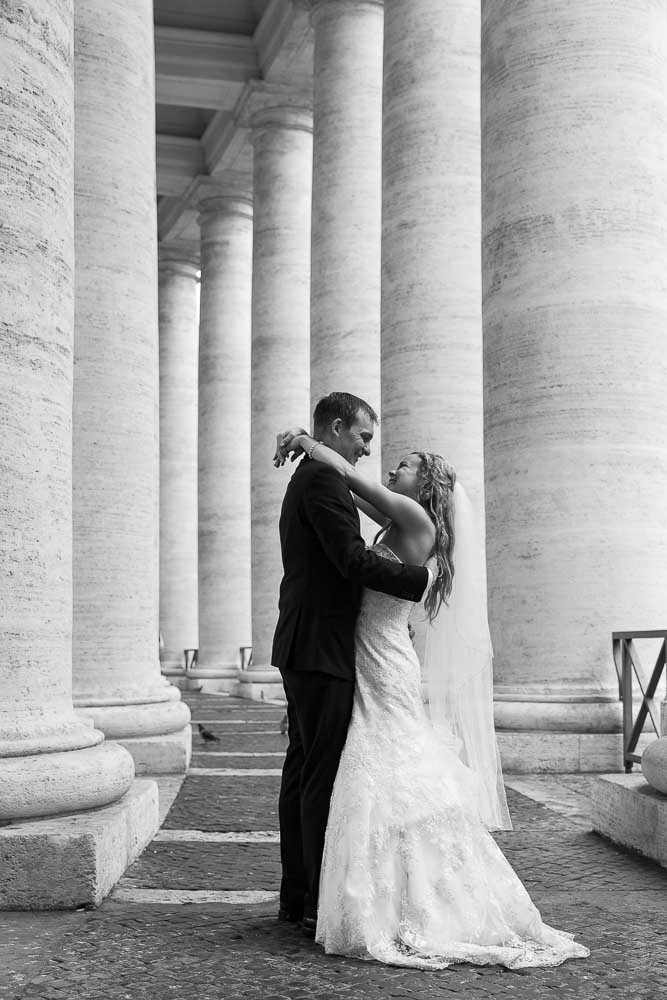 Bride and groom together under the Saint Peter's colonnade