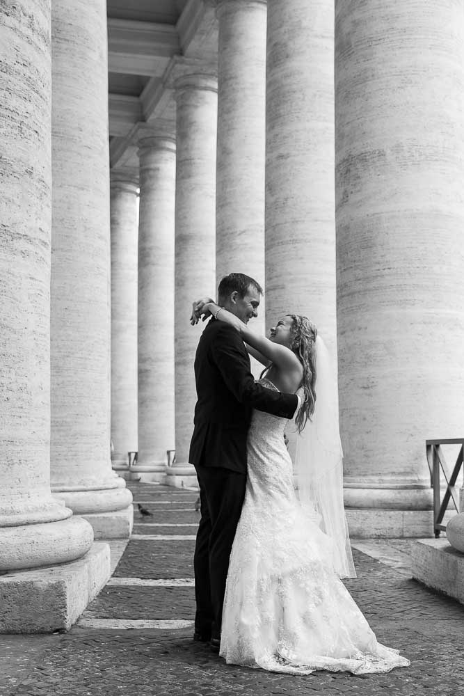 Bride and groom together under the Saint Peter's colonnade