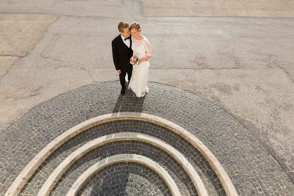 Bride & Groom posing during a newlywed photo shoot. Roman circular staircase.