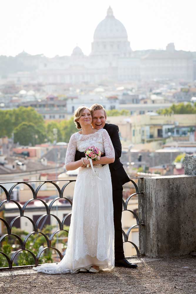 Posed picture before the roman panoramic view leading into Saint Peter's dome in the far distance