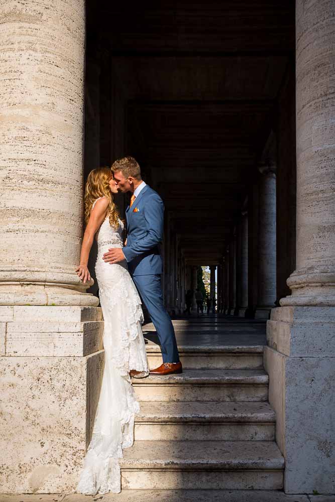 Newlyweds leaning against an ancient marble column