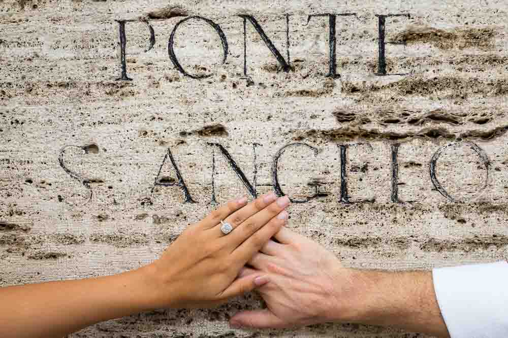 Engagement ring photographed on top of a marble sign