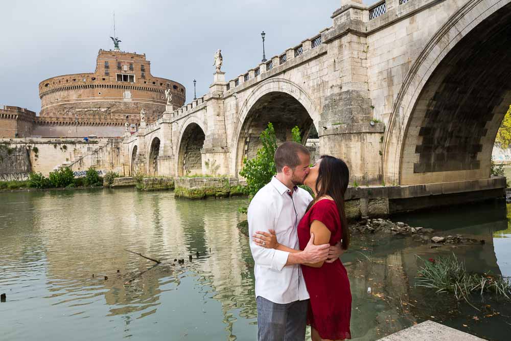 Together in Rome under the Castel Sant'Angelo bridge next to the Tiber river bank