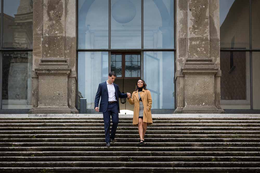 Couple descending stairs while holding hands photo session
