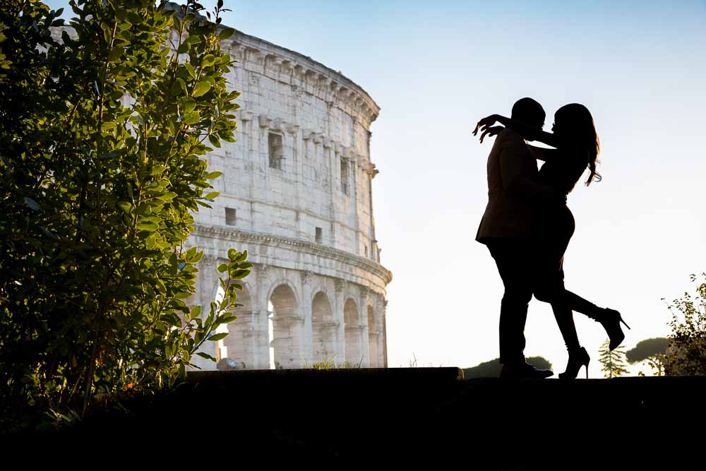 Silhouette image of a just engaged couple at the Roman Coliseum. Rome, Italy.