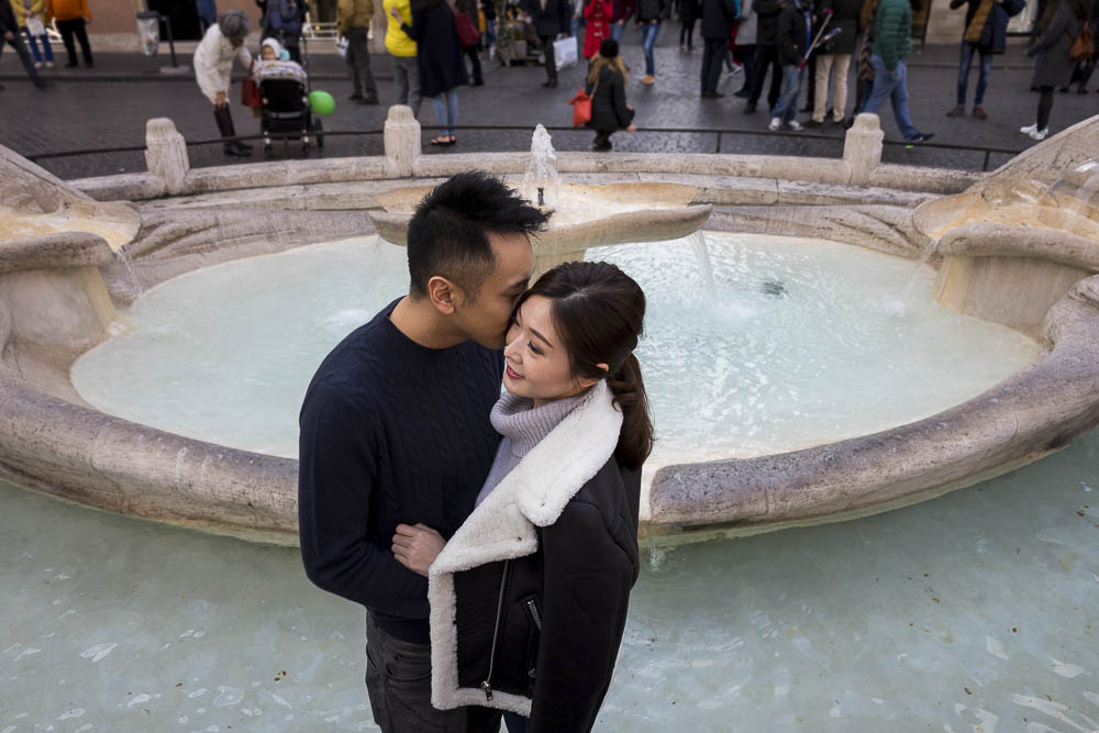 Engaged and in love by the Barcaccia water fountain at the bottom of the Spanish steps