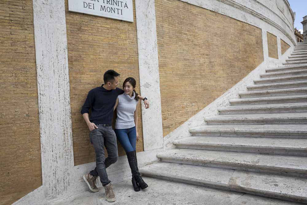 Couple taking photos on the Spanish steps in Piazza di Spagna Roma