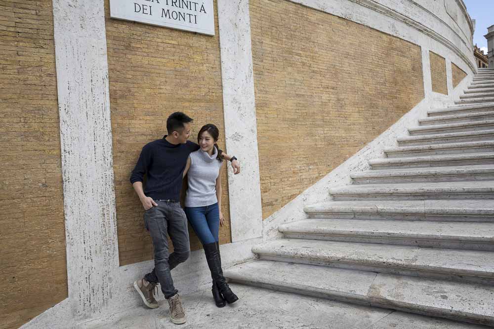 Couple taking photos on the Spanish steps in Piazza di Spagna Roma
