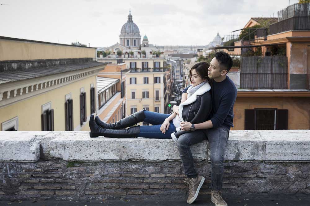 Sitting down portrait picture together in front of roman rooftops