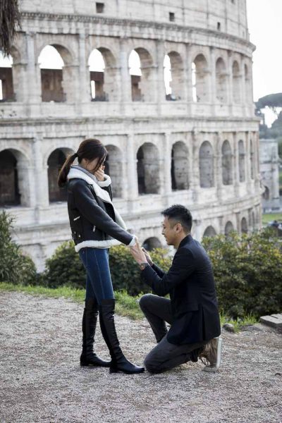 Sitting down wedding marriage proposal at the Roman Colosseum