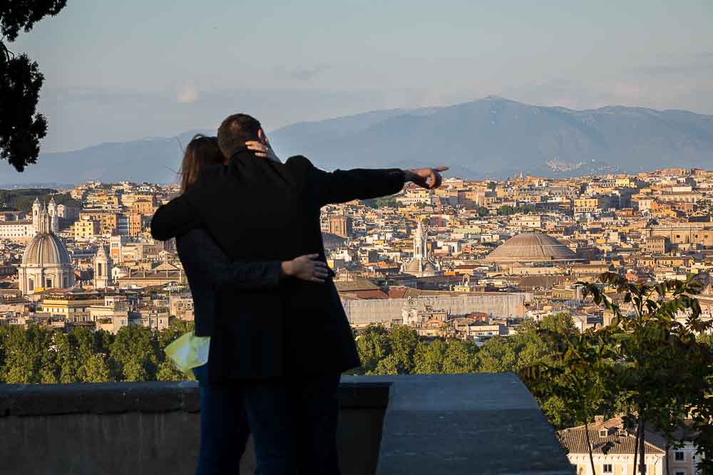 Pointing to the roman rooftops. Panoramic view