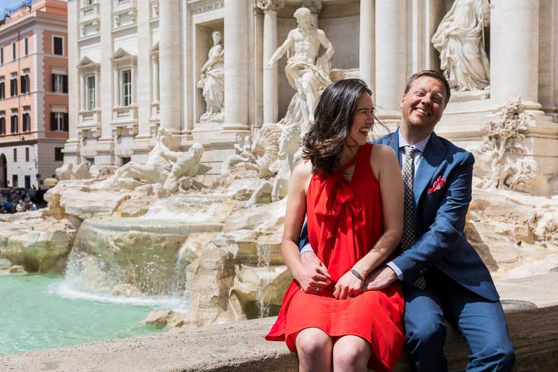 Newlyweds having fun at the Trevi fountain in the heart of Rome