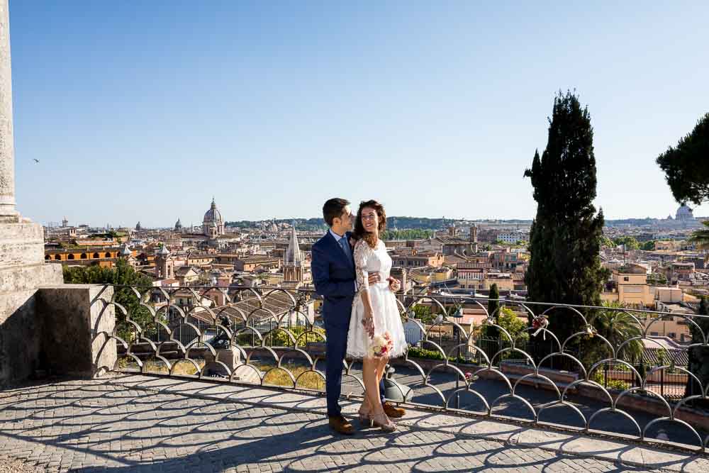 Standing together by the terrace view of the ancient city from Parco del Pincio