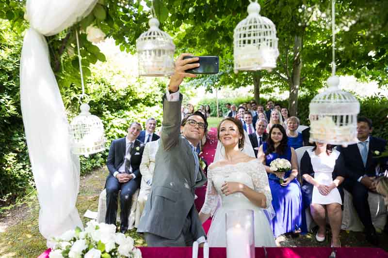 Wedding selfie after the ceremony with the participants as backdrop