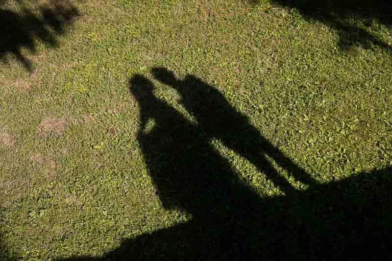 Wedding couple shadows while kissing