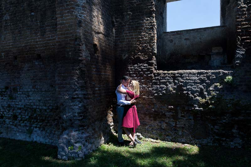 Light and shadow image of a couple by ancient roman walls