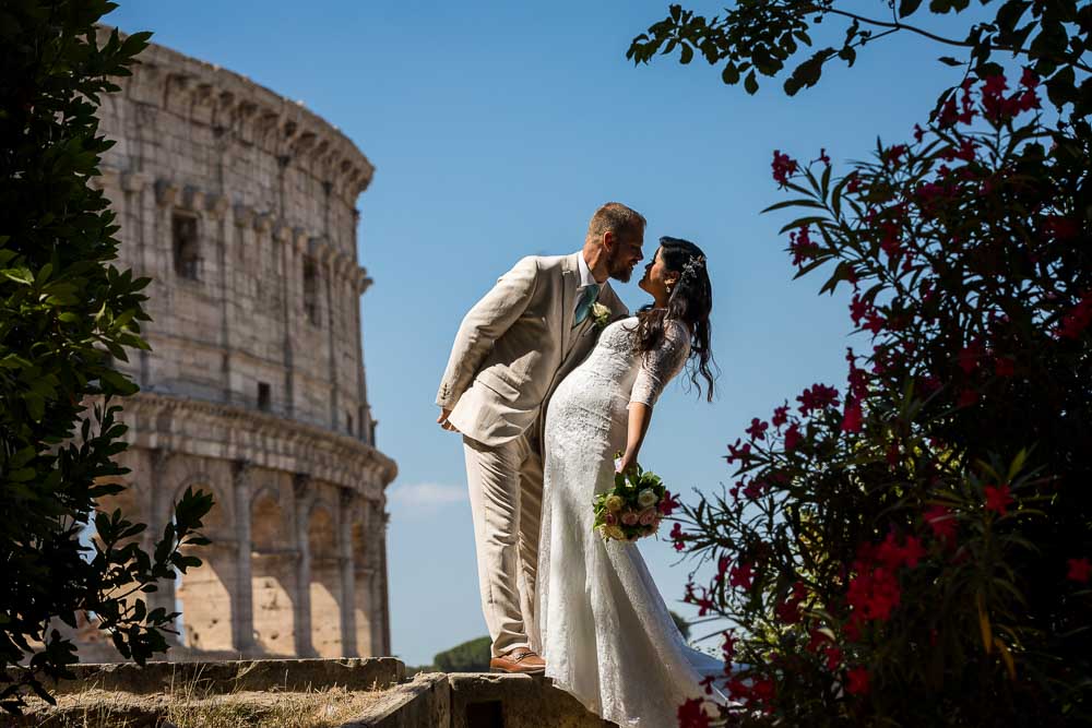 Newlyweds kissing at the Roman Colosseum during a photography session in Rome Italy