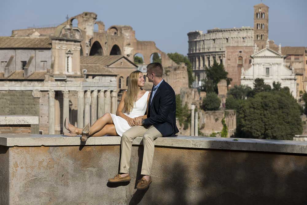 Sitting down portrait with the ancient city in the background. Engagement Photos in Ancient Rome