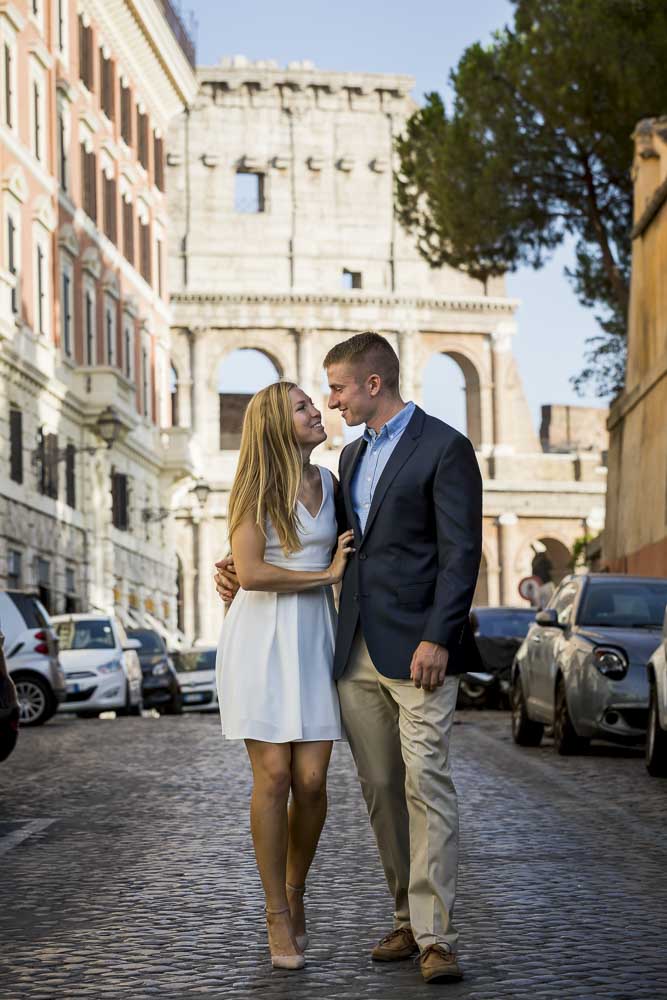 Walking together in an alleyway with the Coliseum as backdrop