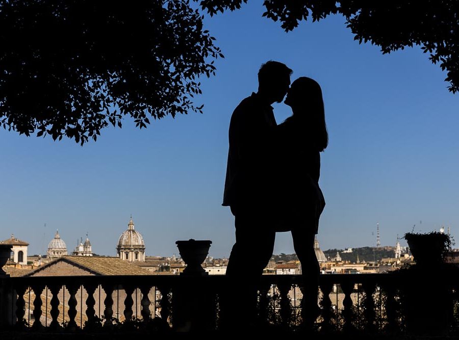 Silhouette image of couple photographed over the roman skyline