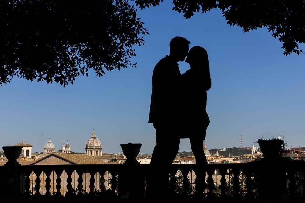 Silhouette image of couple photographed over the roman skyline
