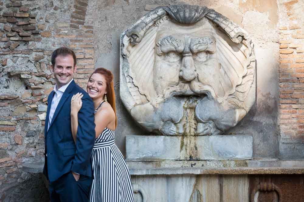 Couple portrait picture taken in front of a scenic roman water fountain