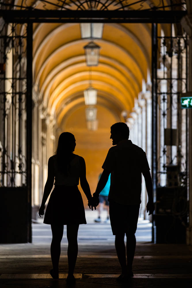 Couple in silhouette holding hands during photo shoot