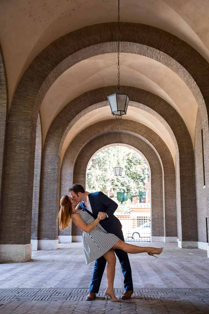 Romantic posed photo of a couple underneath geometrical arches