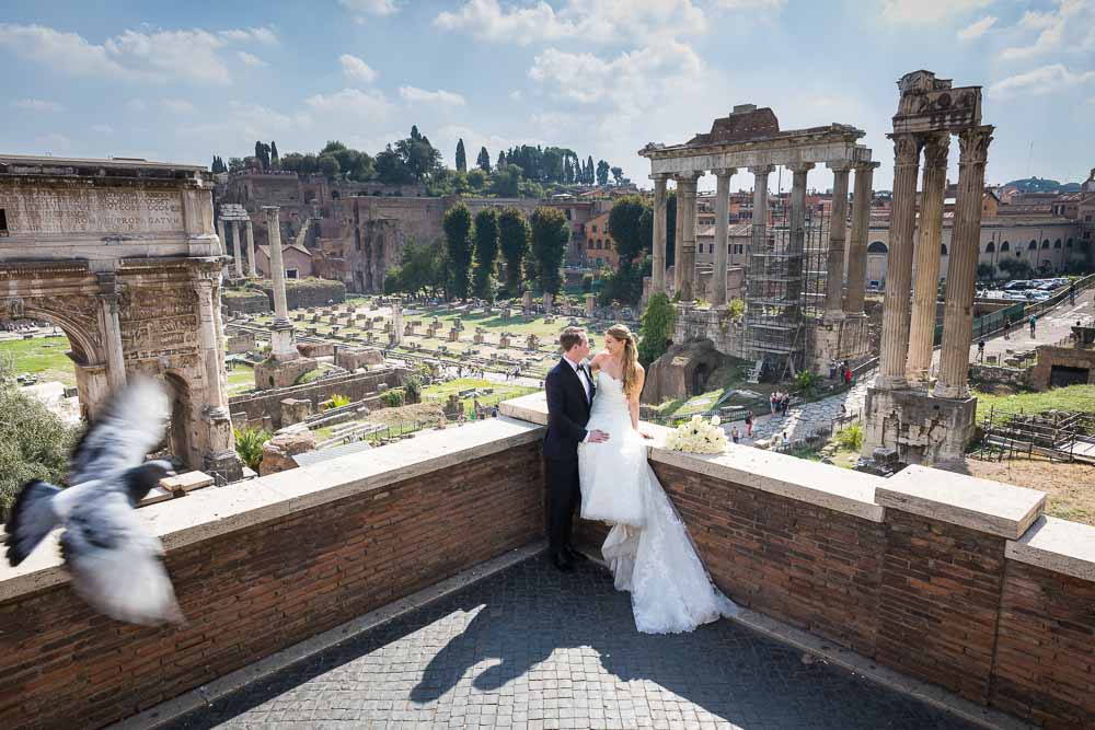 Just married and taking pictures in the ancient roman city with the ruins and monument sin as backdrops