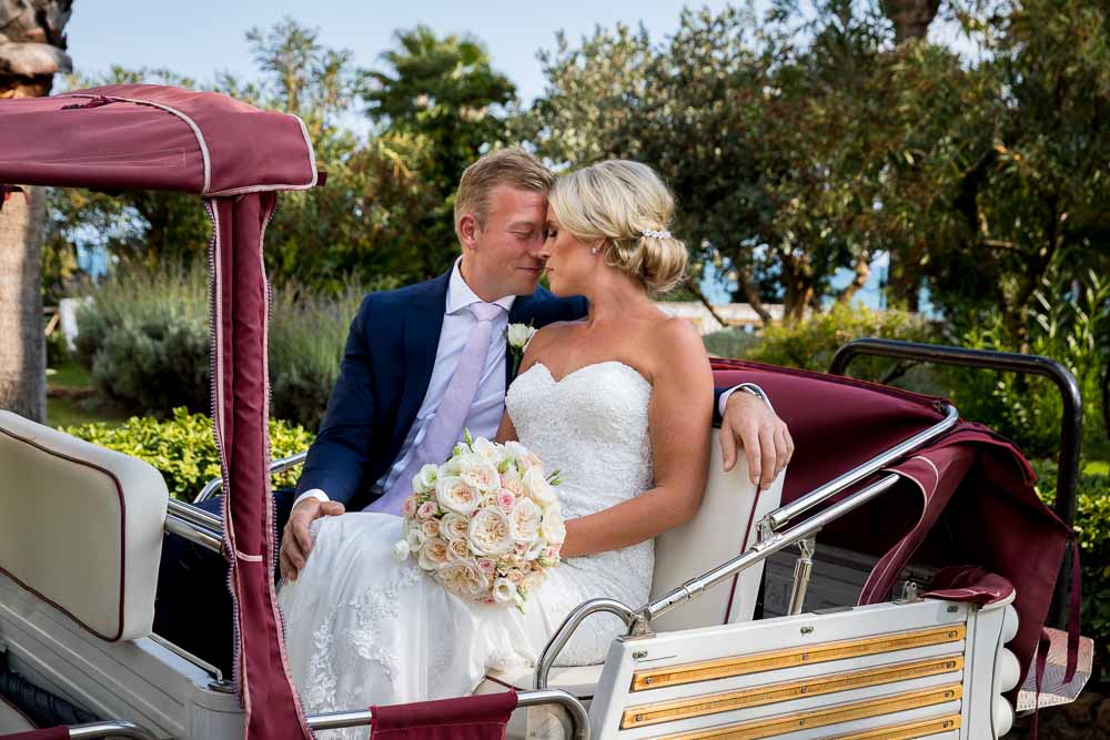 Groom and bride inside ape mini cart