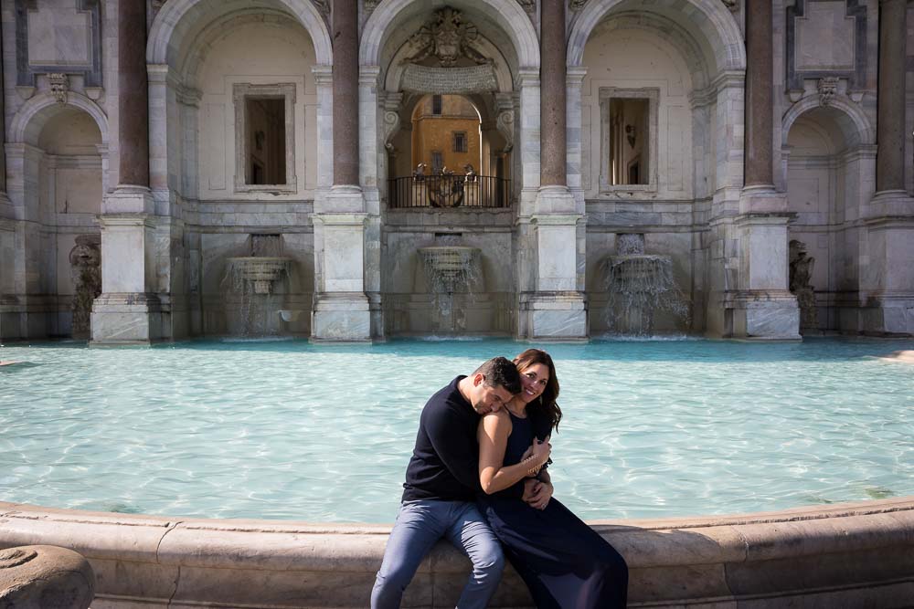 Sitting down pose by the edge of the water fountain