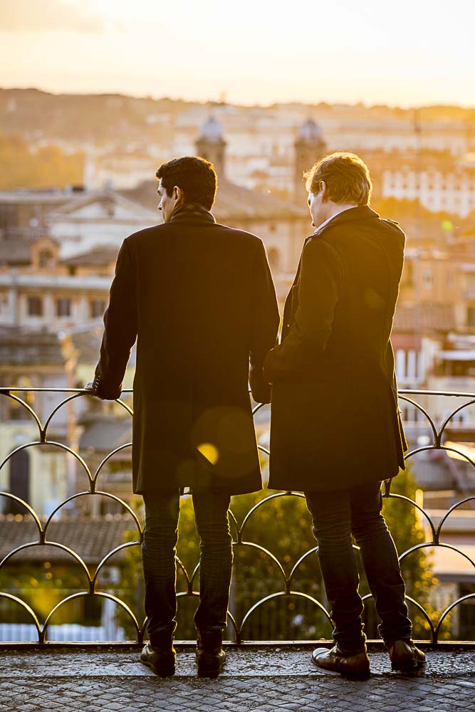 Couple together looking at roman skyline at sunset